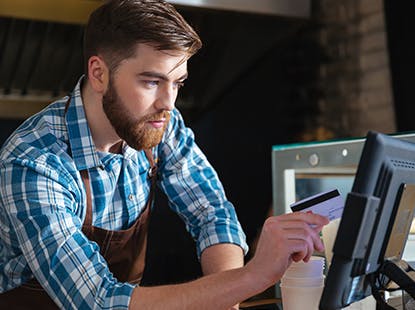 Man working at a point of sale terminal