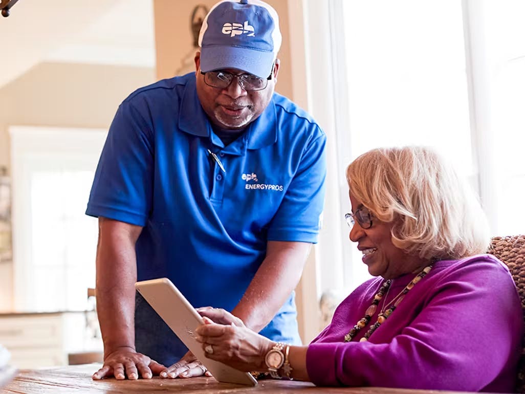 Energy Pro helping woman with iPad