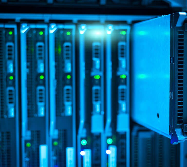 Photograph of a server rack with multiple servers installed, one server partially pulled out to show its front panel. Blue lighting highlights green status indicator lights on each server, emphasizing active network or data center equipment.