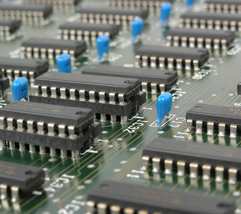 Detailed macro shot showcasing integrated circuits and components on electronic motherboard.