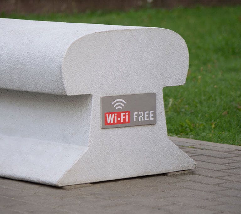 Image of a 'free wi-fi' sign visible through a translucent yellow surface, suggesting the interior of a cafe or public space.