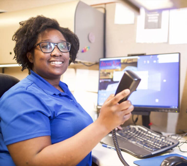 EPB employee at desk using phone