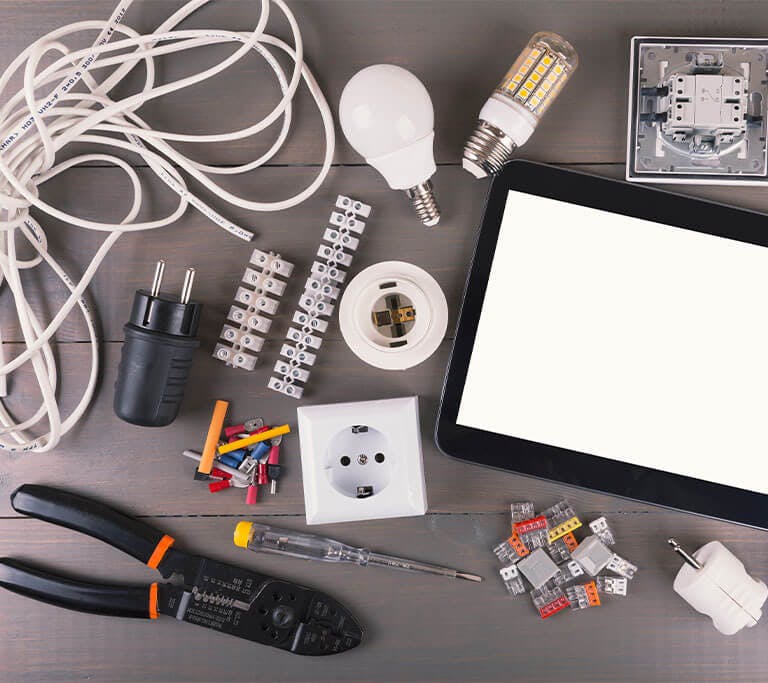 blank digital tablet with electrical tools and equipment on wood