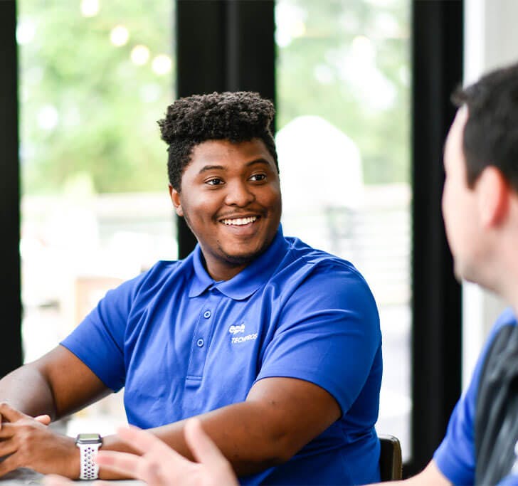 An EPB Fiber Optics employee talking with another person in blue shirt.
