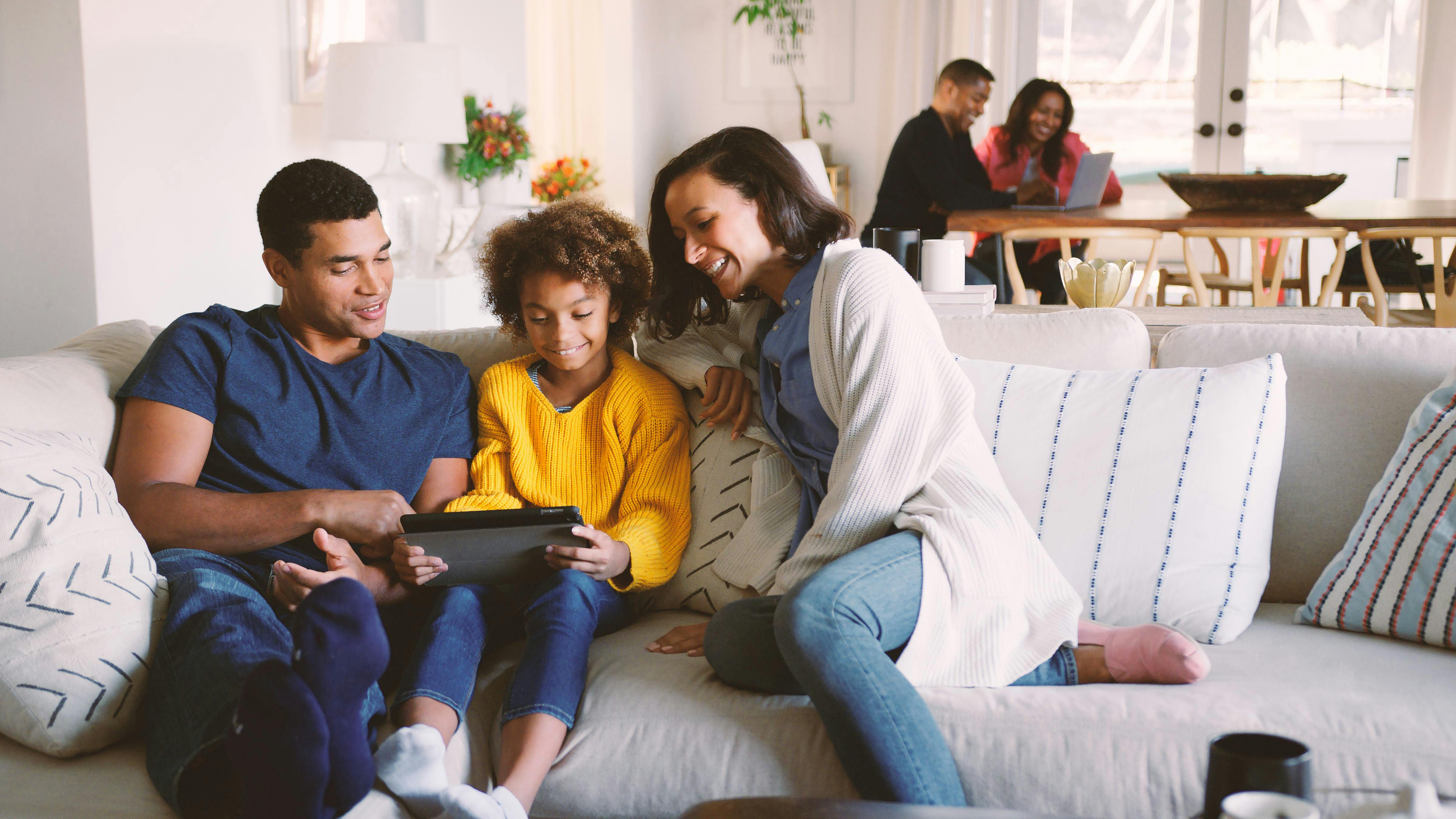 family-relaxing-on-sofa-with-digital-tablet.jpg