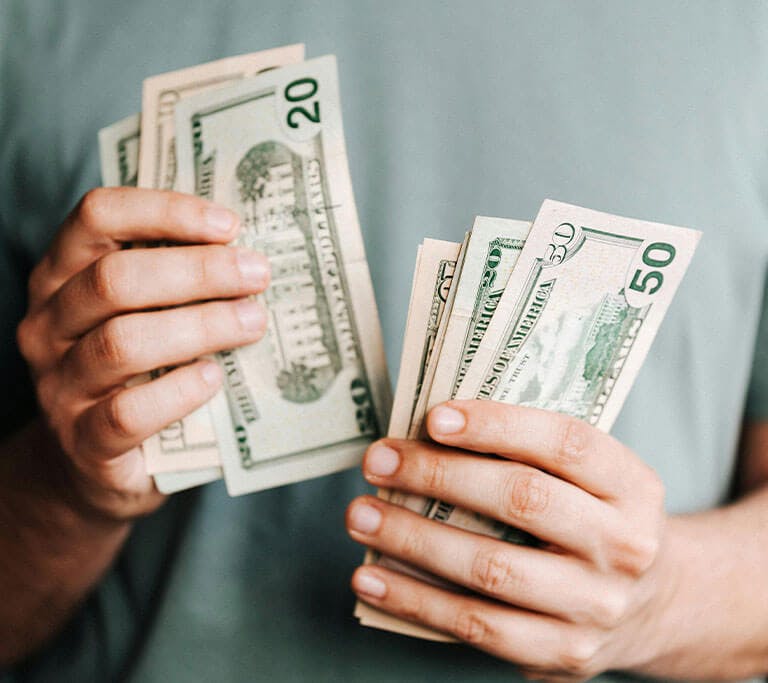 A man is counting all the money he saved from buying an energy efficient water heater or boiler.