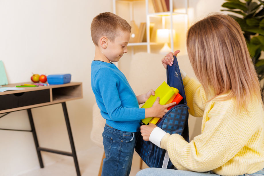 mother-helps-son-pack-backpack-with-books-and-supp-2025-08-18-01-36-48-utc.jpg