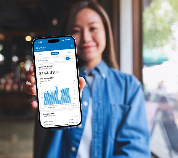 woman holding phone displaying MyEPB app