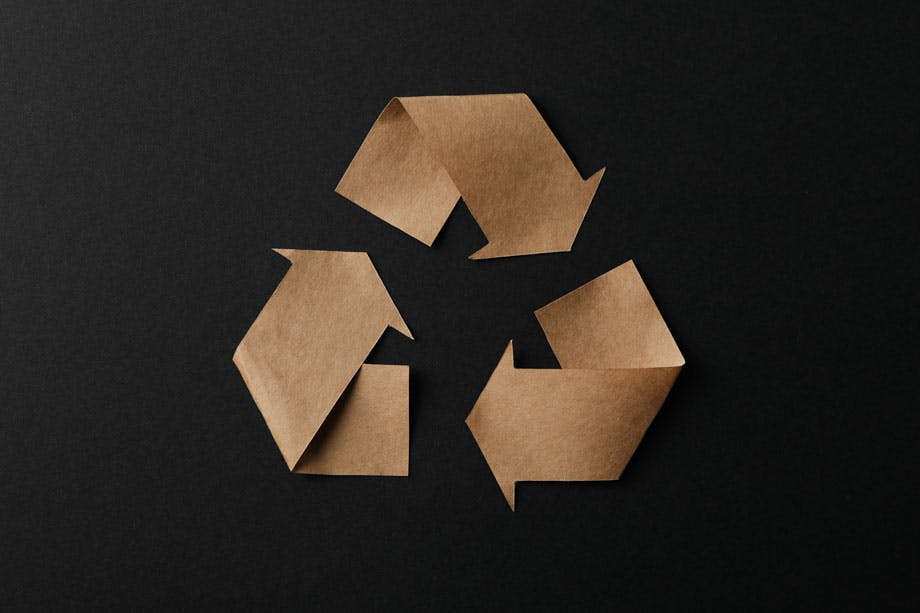 recycling-sign-on-black-background-top-view-2026-03-24-23-37-49-utc.jpg