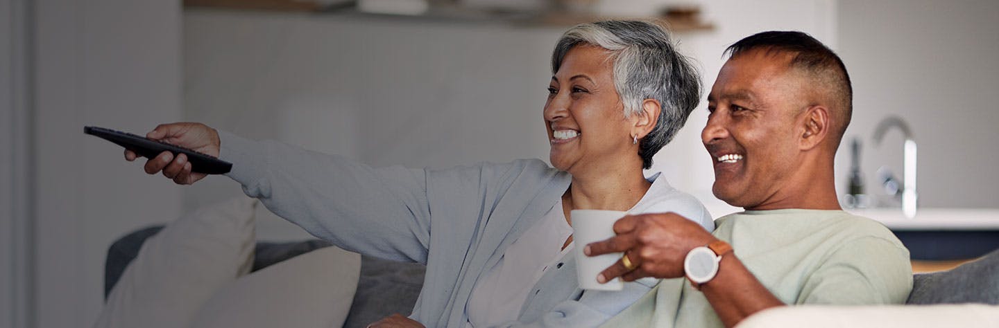 senior-couple-watching-tv-and-relax-on-couch-in-h-2025-04-06-12-35-52-utc.jpg