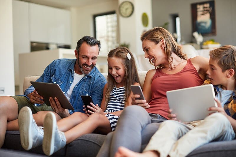 Happy family on their wireless devices